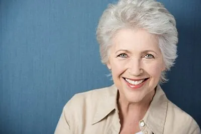 woman smiling with dentures from Berg Dental Group