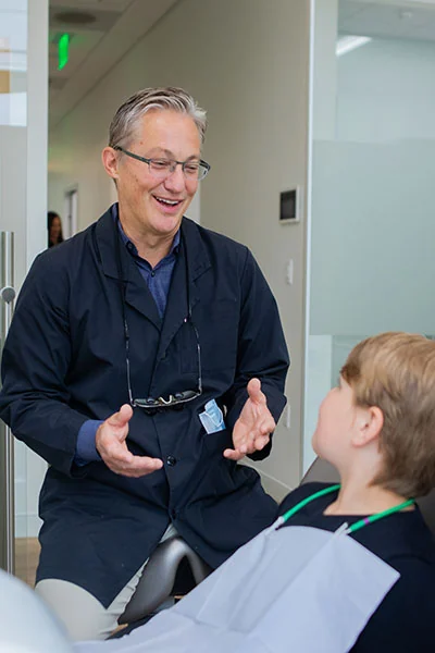 Dr. Berg speaking with child preventive patient at berg Dental Group